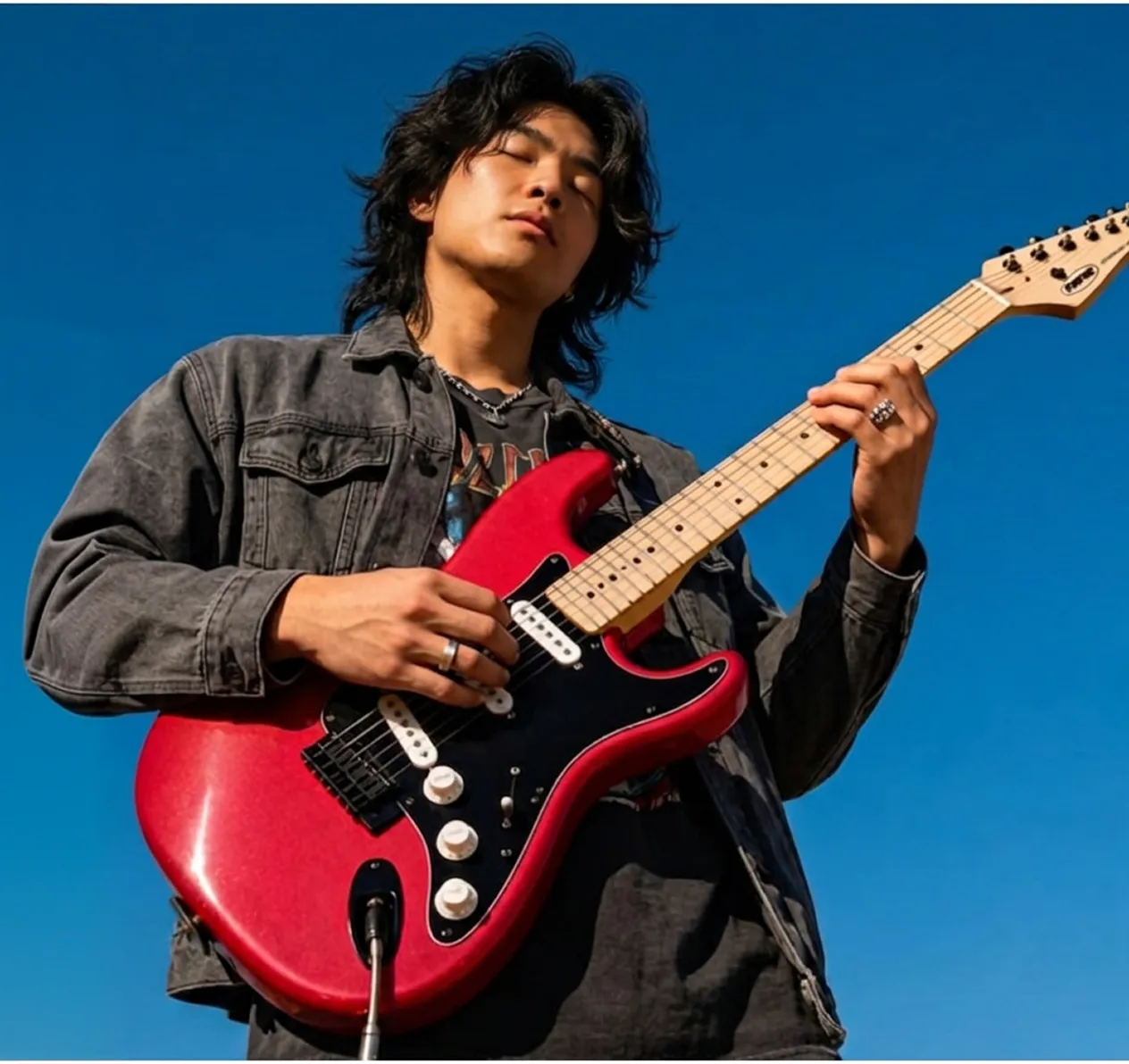 a-guy-playing-a-red-guitar-3